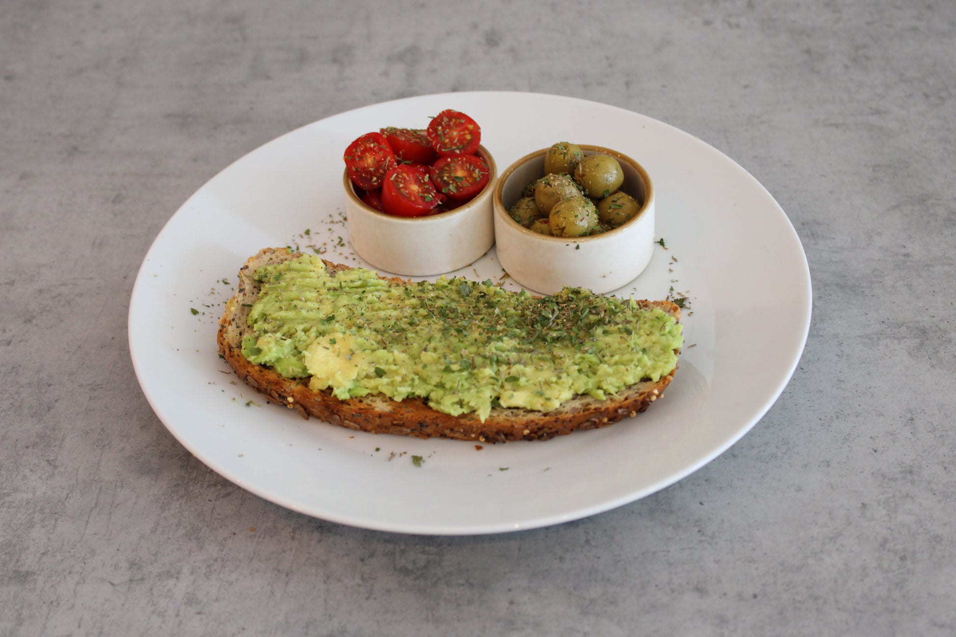 Smashed Avocado on Toast with Olive and Tomato